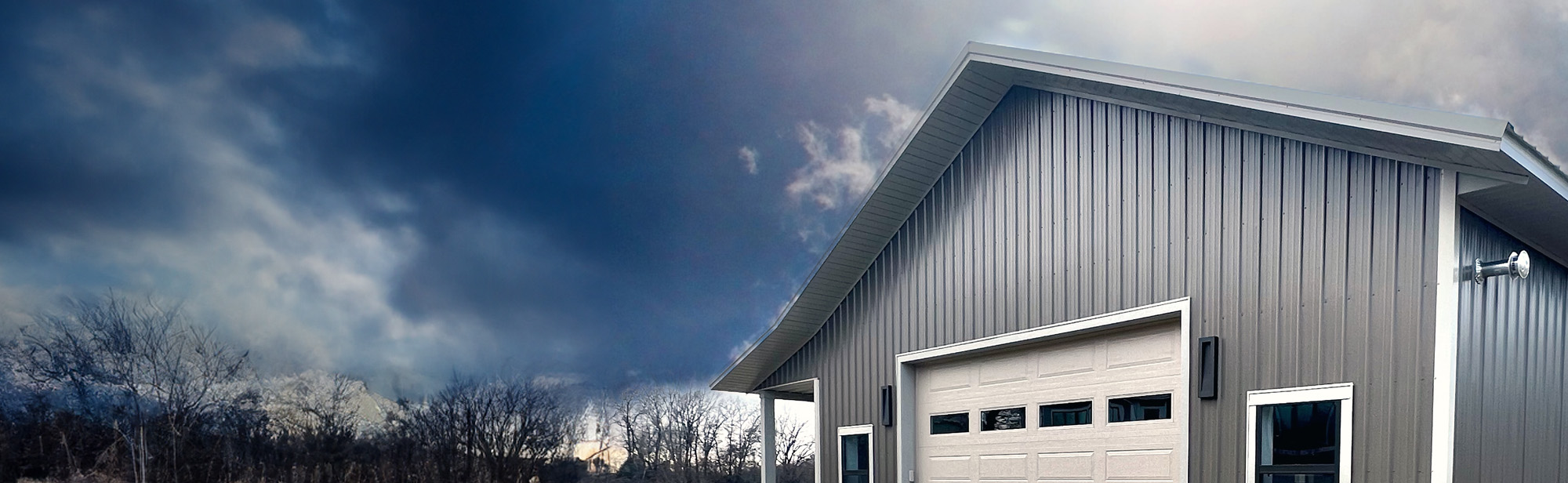 completed barndominium under dark sky