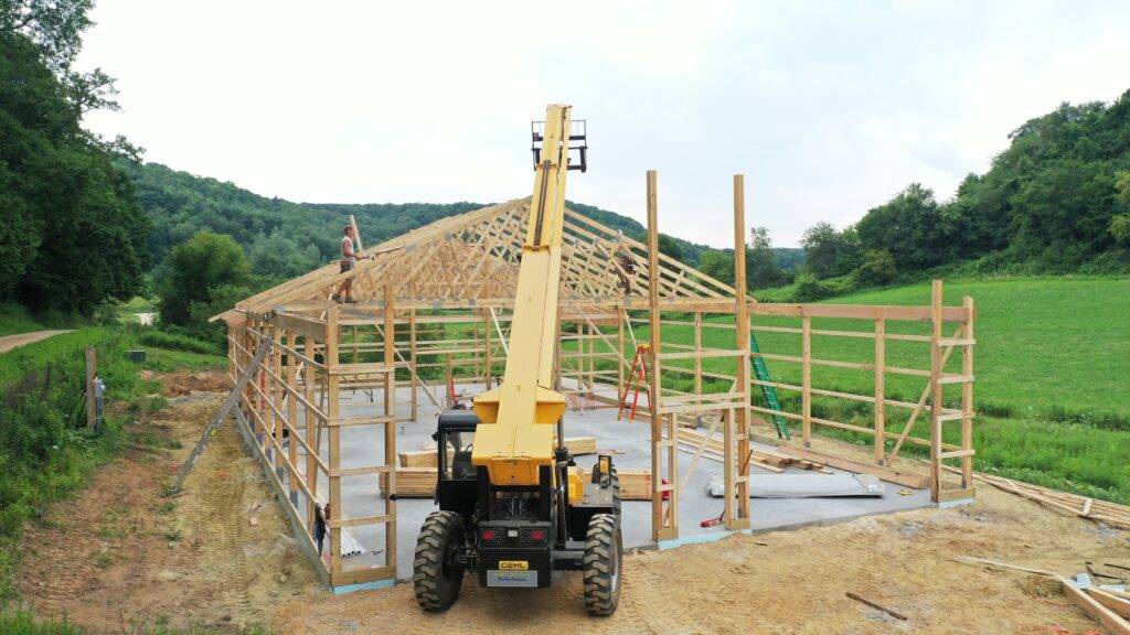 Post frame construction uses wood-framed walls with metal roof and wall panels